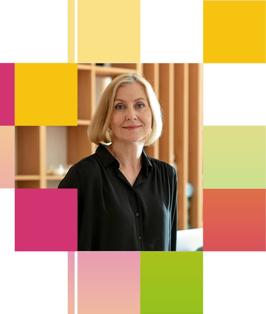 Portrait of a woman in a black shirt in an office.