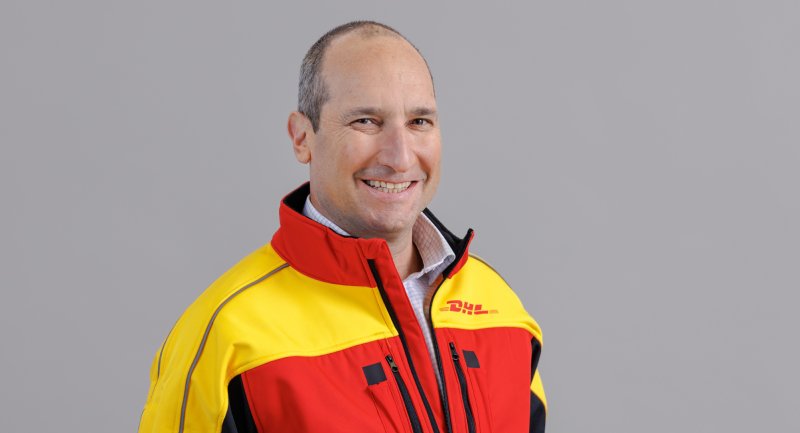 Portrait of Saul Resnick wearing a DHL jacket.