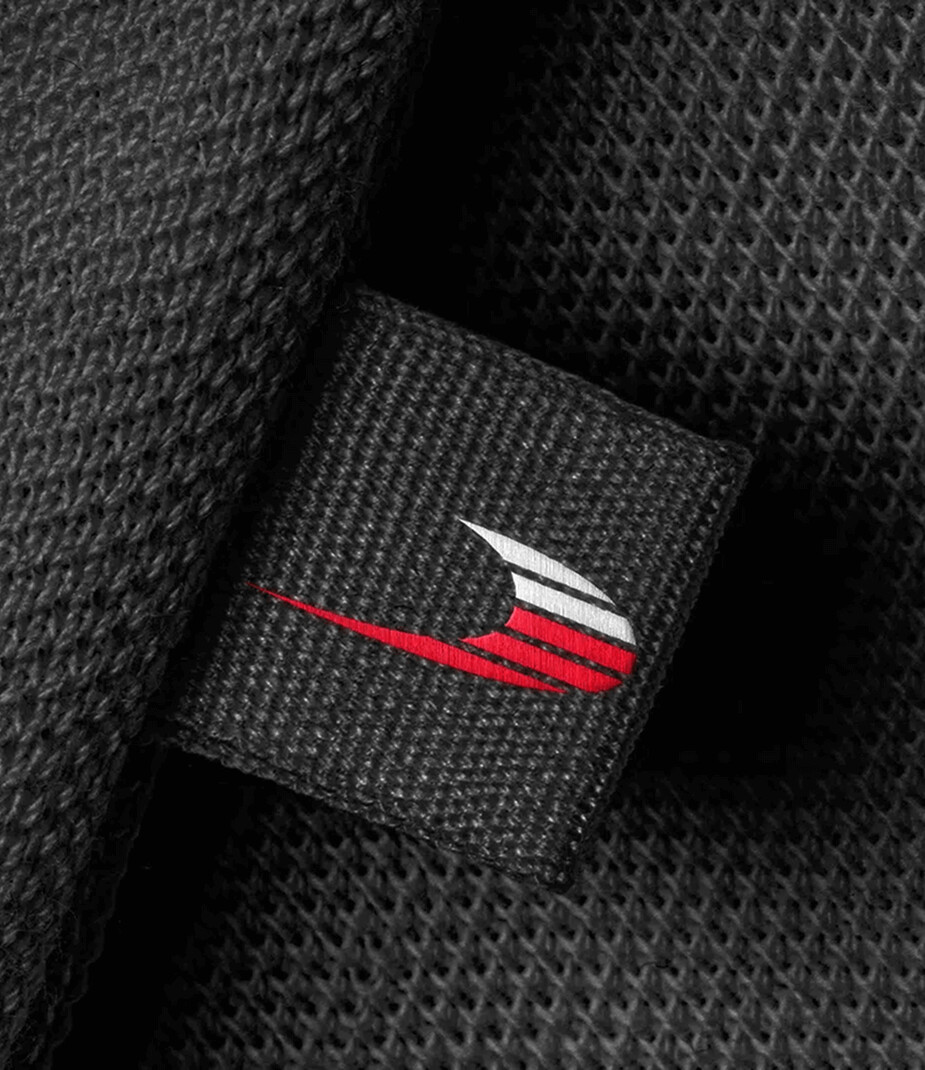 RPM Technik logo stitched on black fabric.