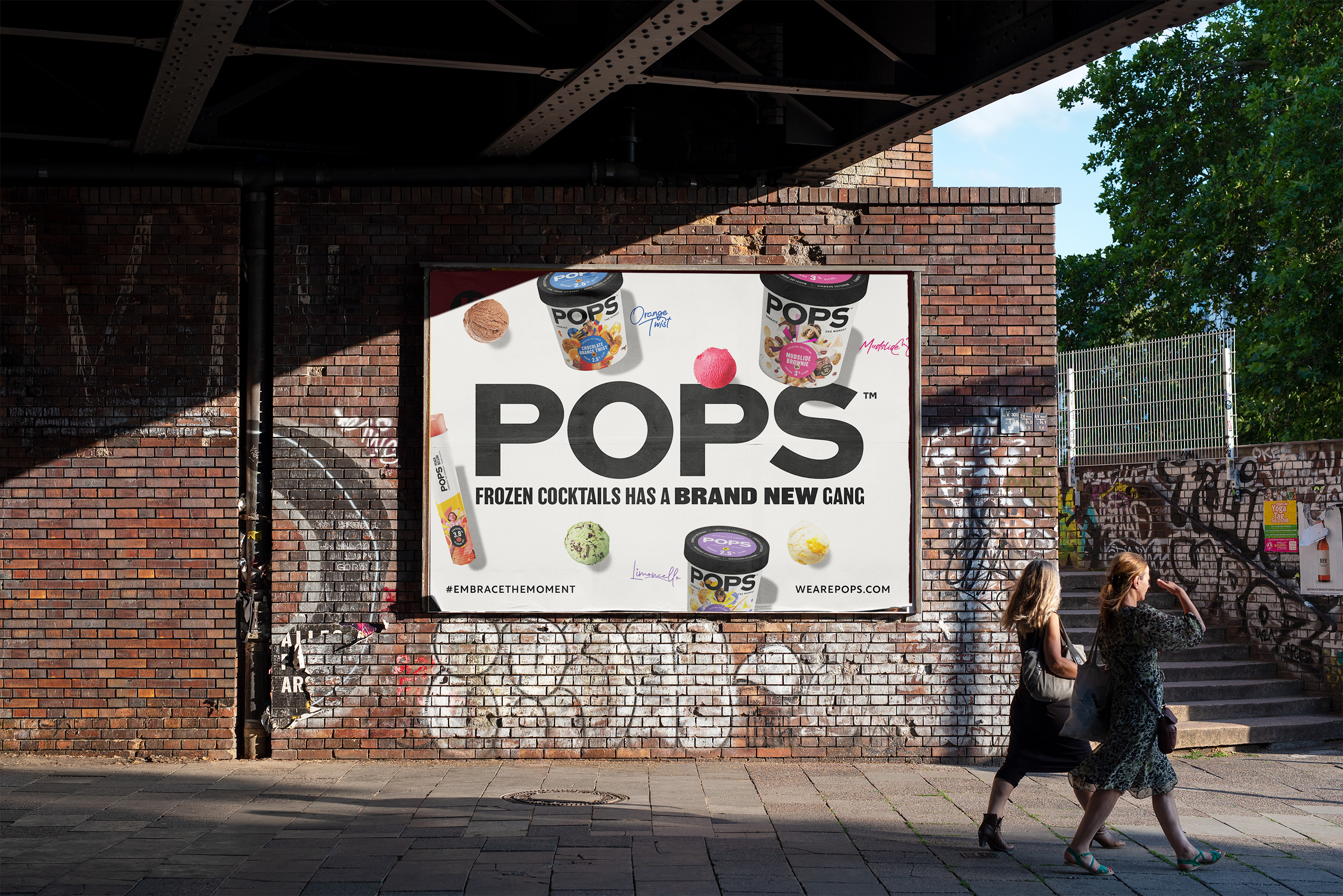 POPS frozen cocktail billboard showcasing different flavours with a bold, playful design under a city bridge.