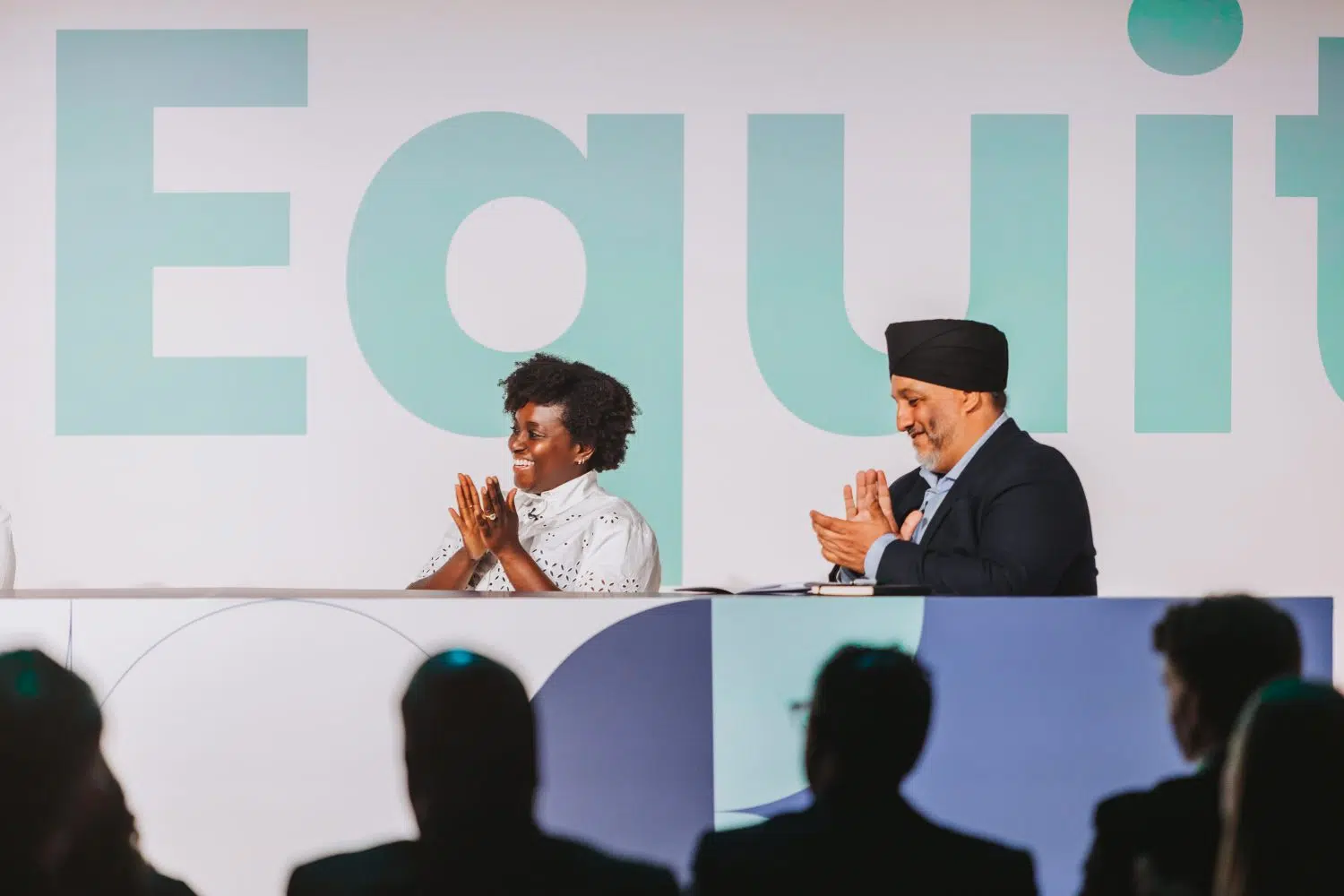 Panelists clapping during the Elevate Equity event hosted by The Open University