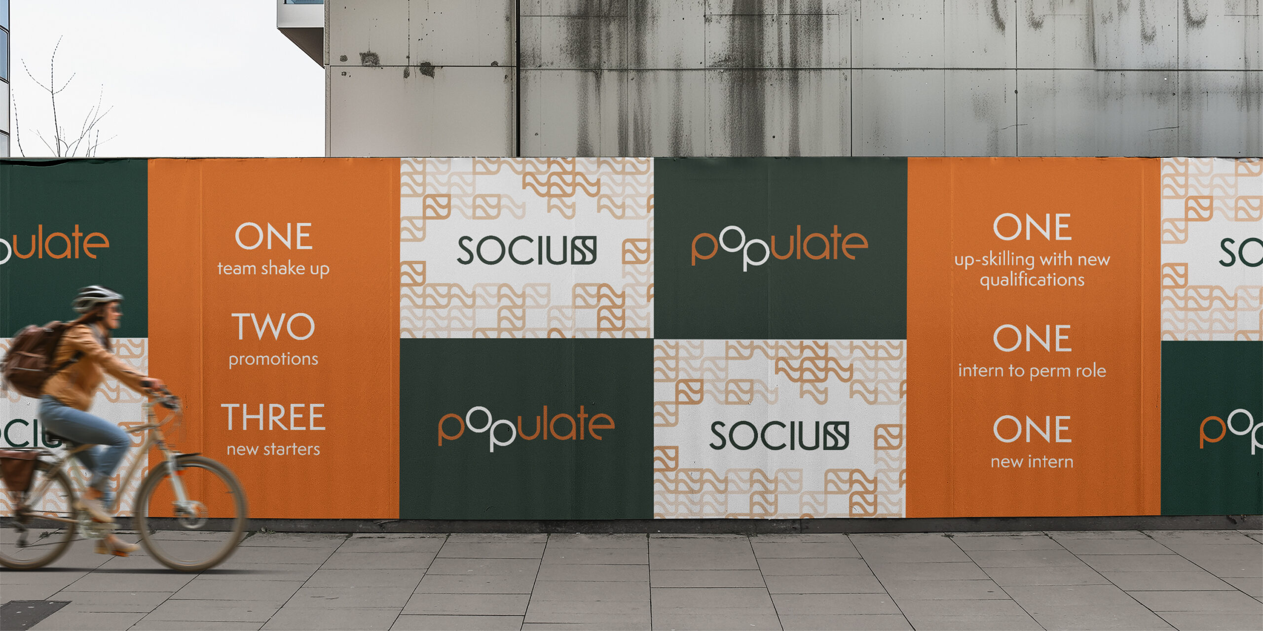 Populate and Socius branded hoarding promoting team milestones and growth.