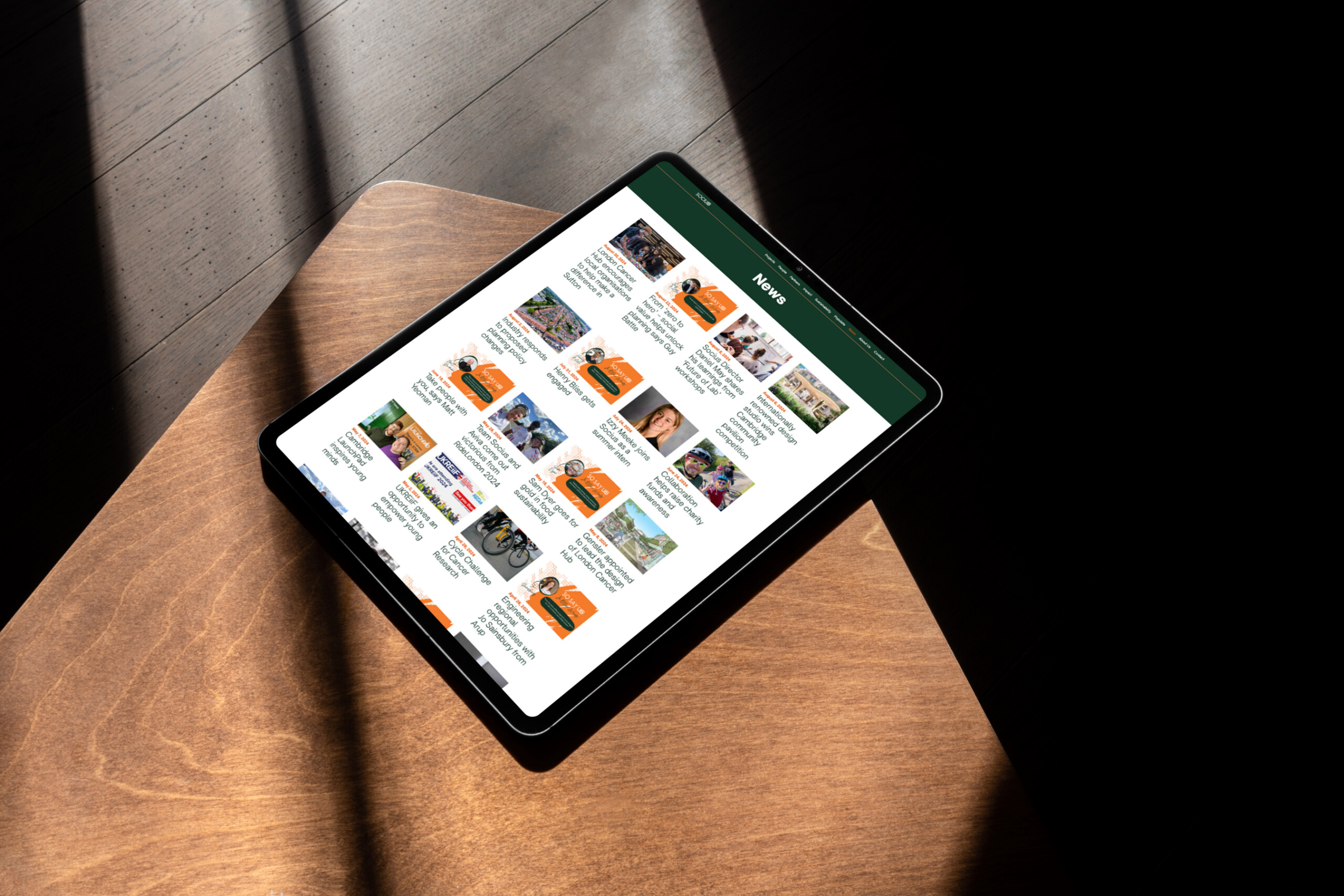 Tablet showing Socius news updates and project stories.