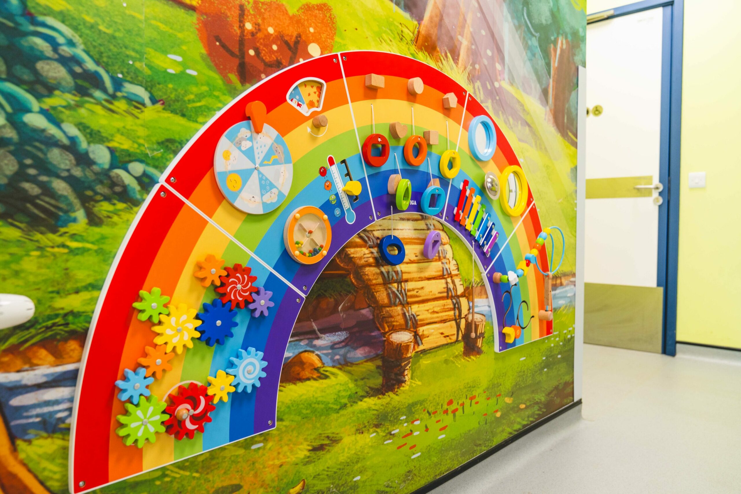  Interactive rainbow wall toy in a children’s hospital ward.