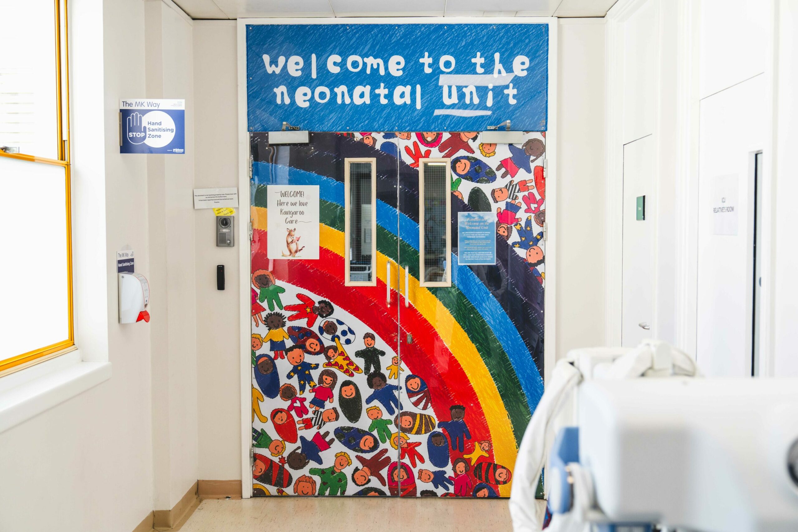 Colourful entrance to a neonatal unit with rainbow and children’s artwork.
