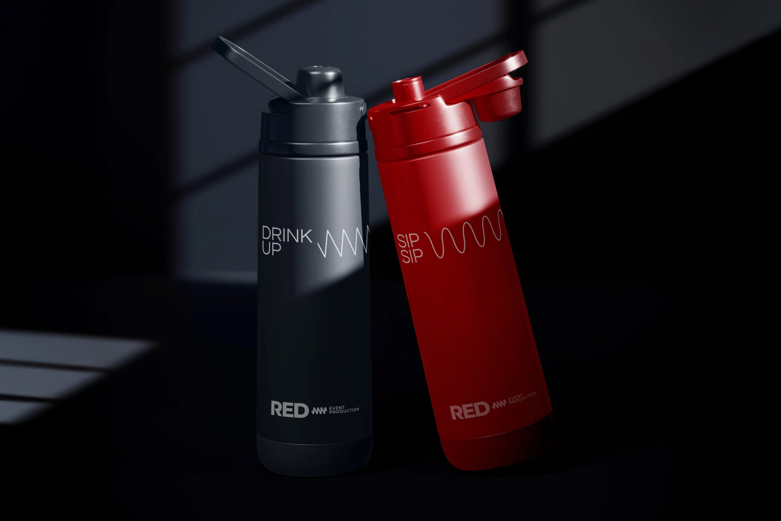 Branded RED water bottles in black and red with slogan text.