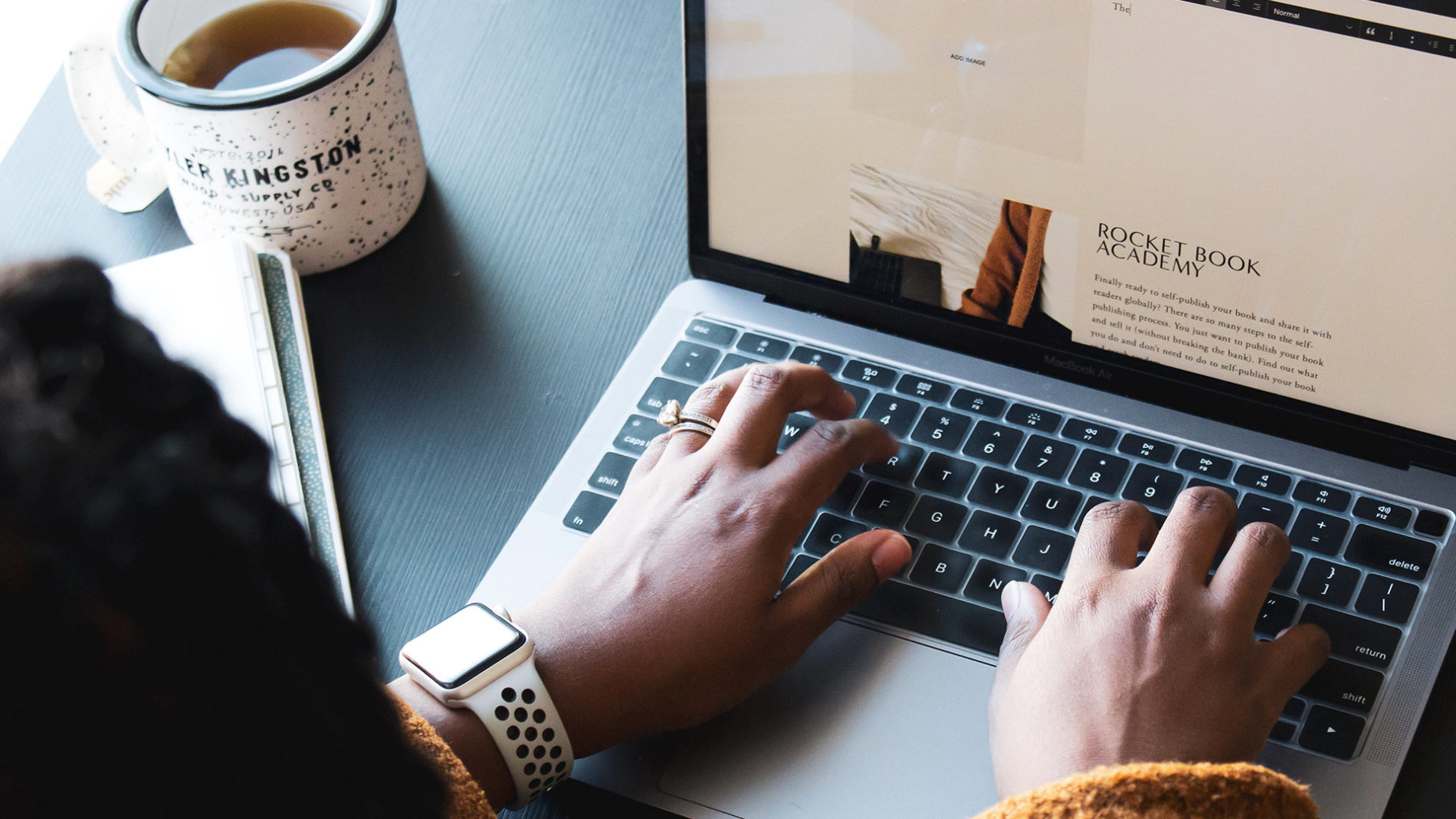 Woman writing in laptop
