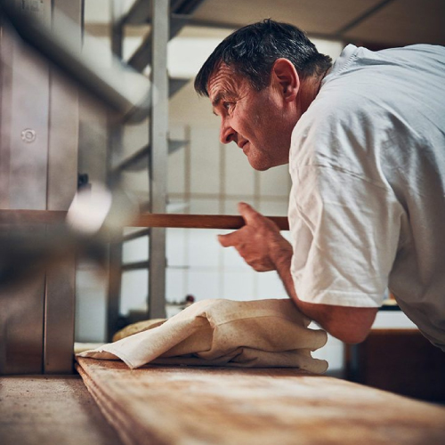 Chef cooking with steam rising in the kitchen.