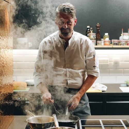 Baker placing bread into the oven.