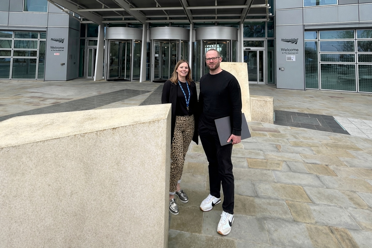 two people in front of an office block