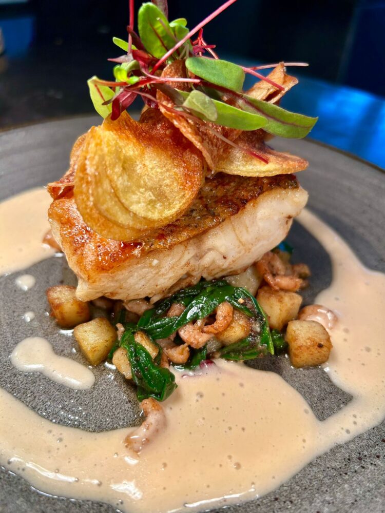 Pan roasted fillet of hake, potato, spinach and brown shrimp fricassee, citrus fennel, potato crisps, blood orange butter sauce