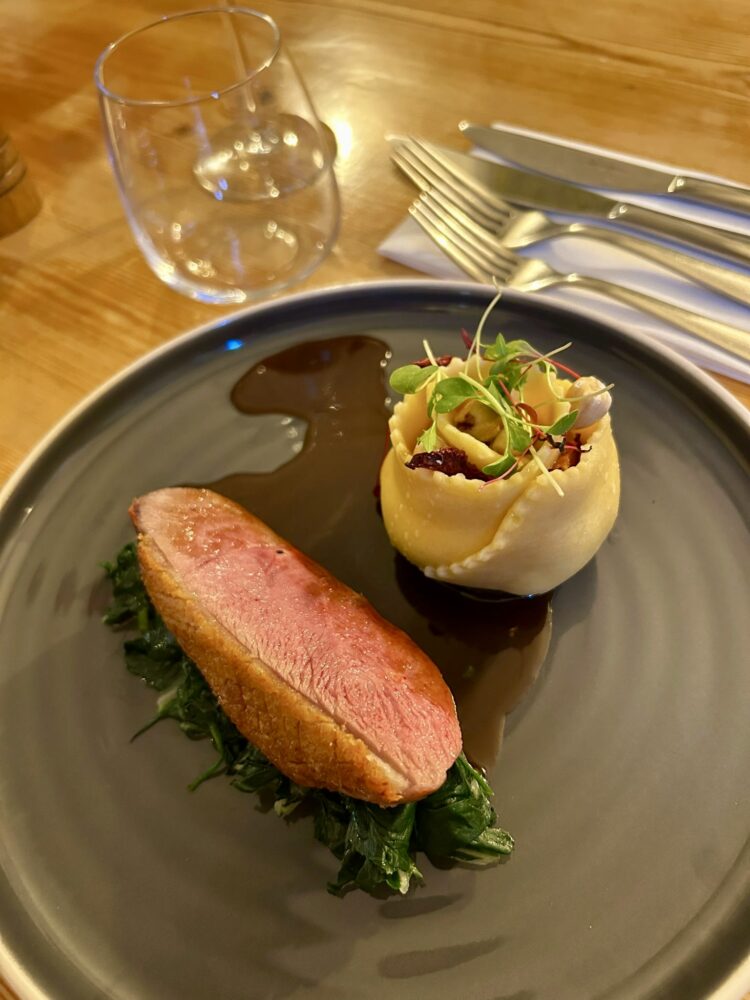 Pan seared Creedy carver duck breast, confit leg rillette, goats cheese pappardelle ripene, hazelnuts, swiss chard, plum sauce