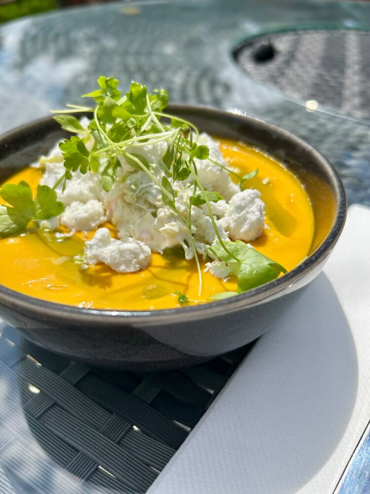Chilled carrot soup, goats cheese and pickled ginger crème fraiche, baby gem