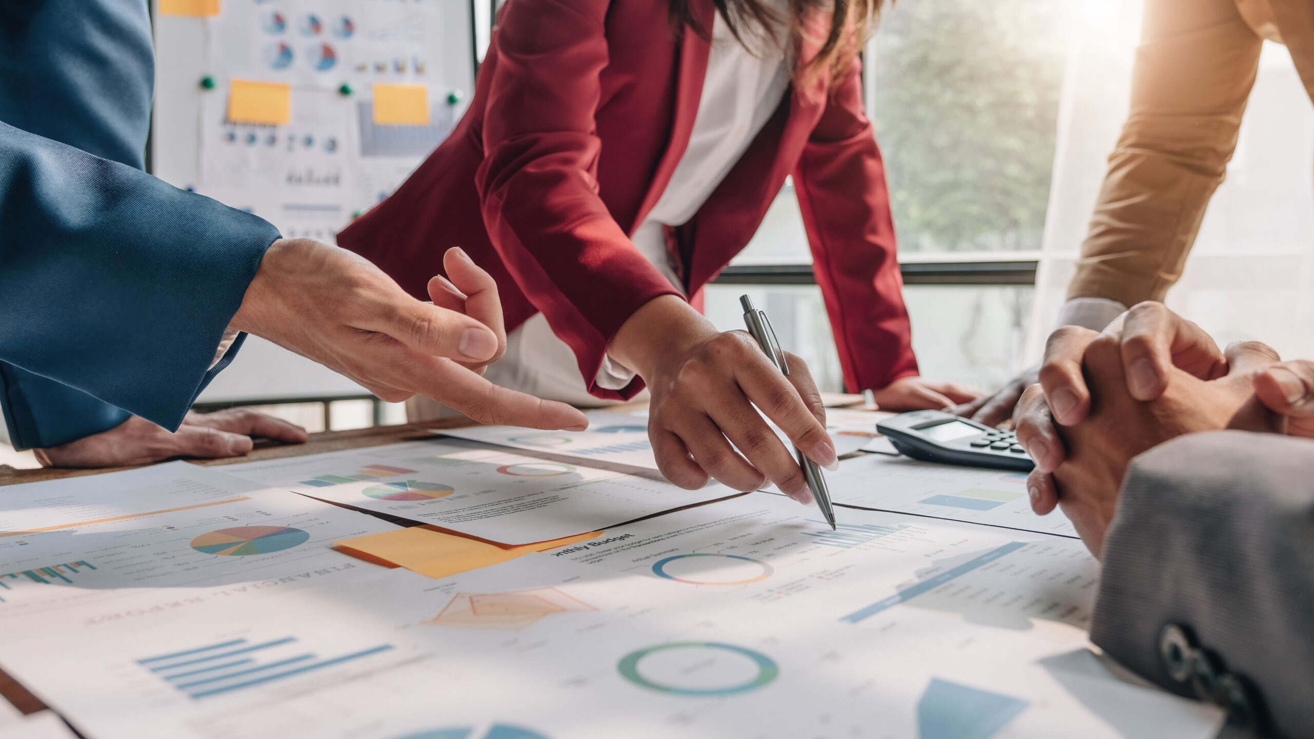 Business meeting people planning around table with plans