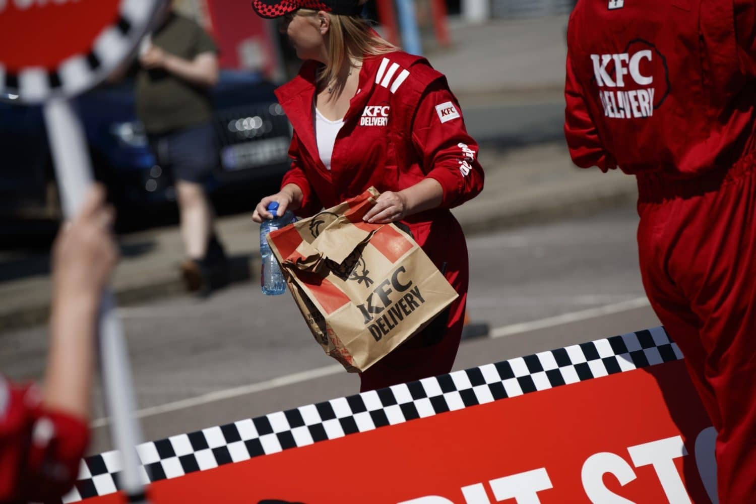 person holding a brown bag from KFC