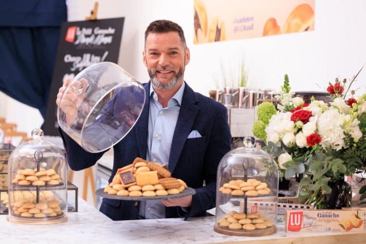 man opening a serving plate filled with cookies