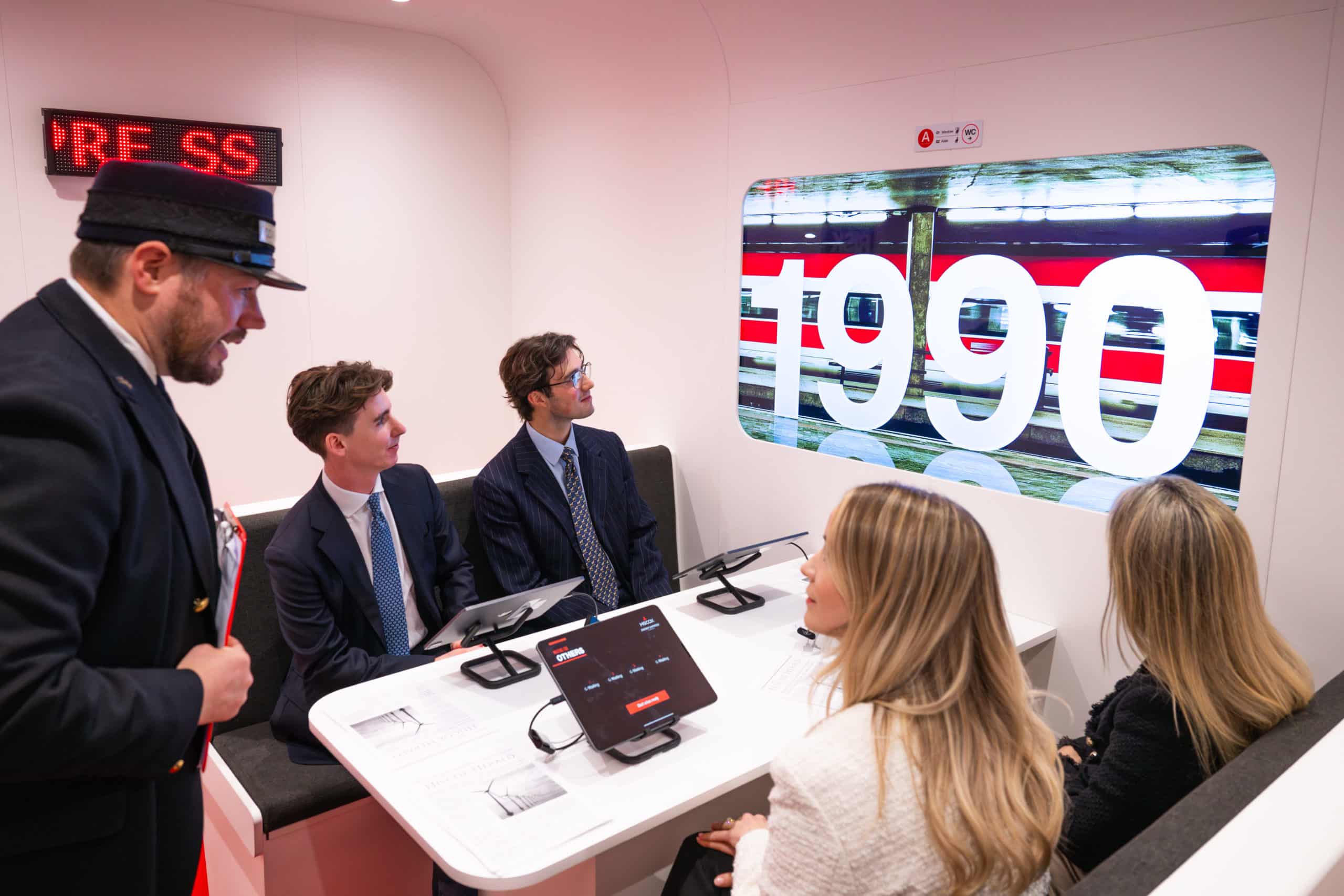 people in a room with a large screen