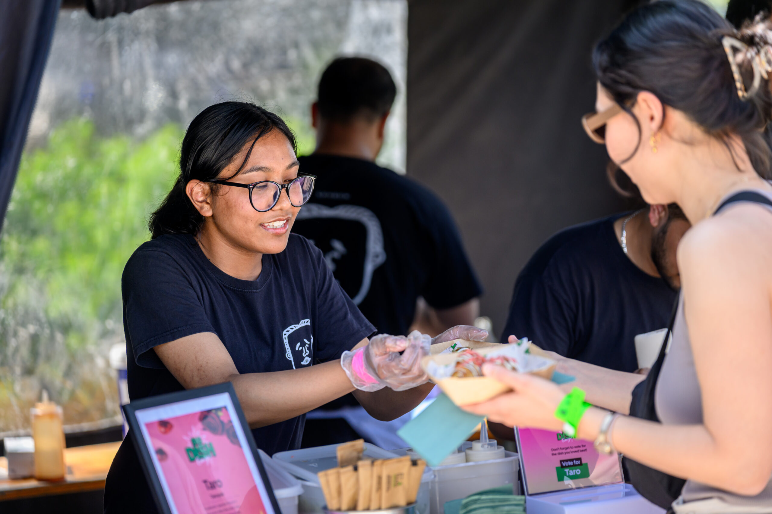 woman serving food from a food tent