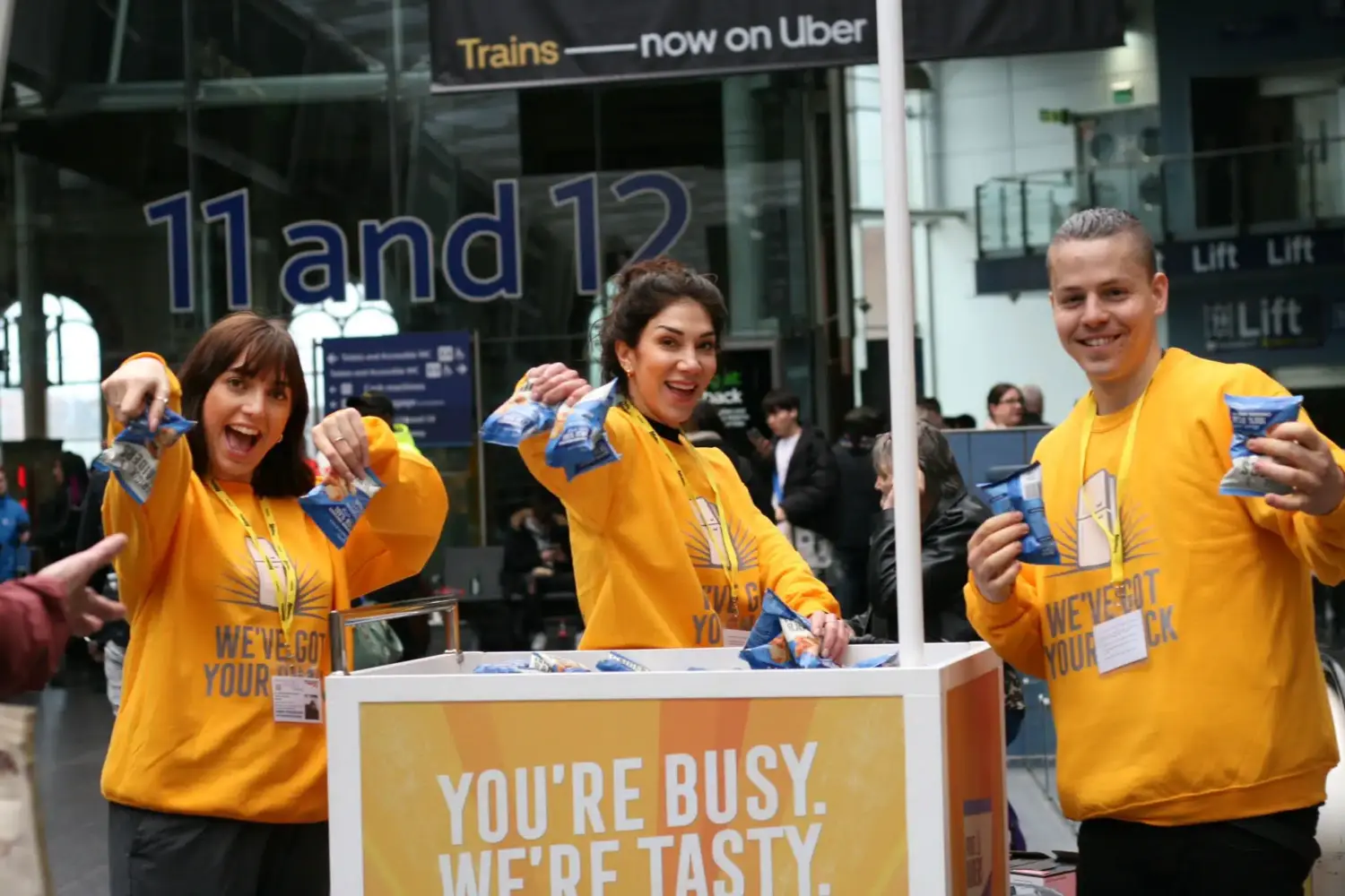 people showing a product in a train station