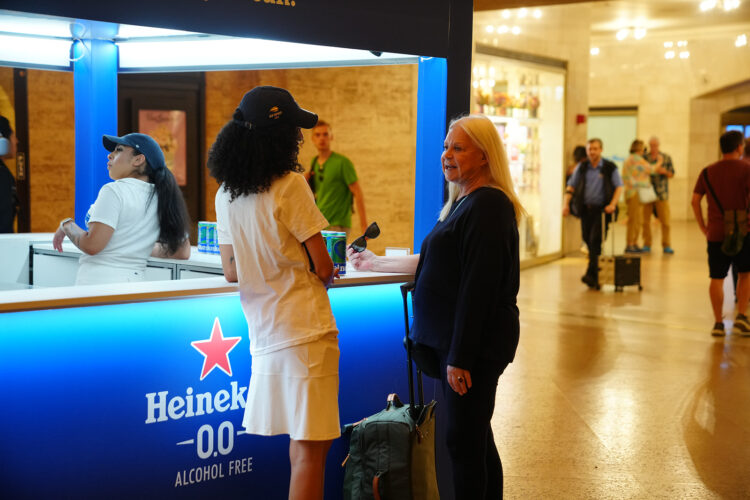 women talking in front of promotional stand